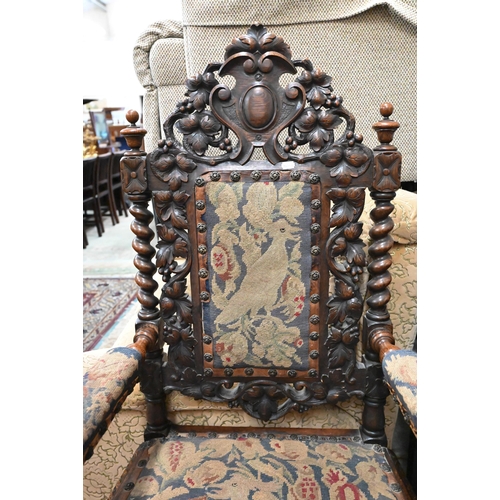 495 - Antique oak open armchair, the barleytwist frame supporting well carved oak leaf design back and lio... 