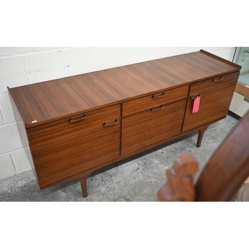 497 - A mid century Meredew rosewood sideboard circa 1960, the drawers and panelled cupboards fitted with ... 