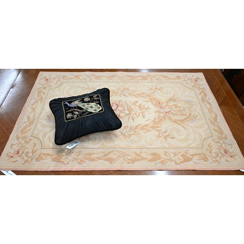 514 - A small Aubusson rug with traditional floral design, beige ground, 120 x 75 cm to/w small black cush... 