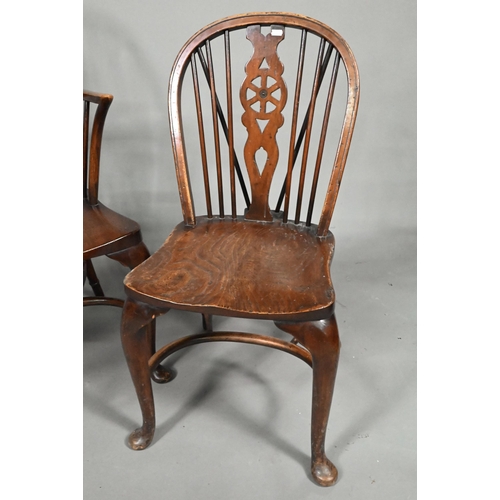 940 - A set of six oak and elm hoop and Windsor dining chairs, raised on crinoline stretchers, comprising ... 