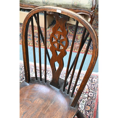 940 - A set of six oak and elm hoop and Windsor dining chairs, raised on crinoline stretchers, comprising ... 