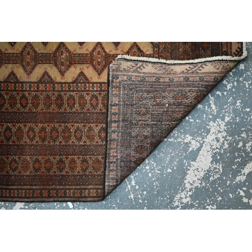1055 - A North East Persian Turkoman rug, camel ground, 224 cm x 124 cm