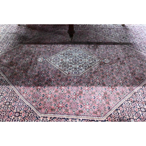 1056 - A Persian Bidjar red ground carpet, centred by a diamond floral lozenge, 335 cm x 247 cm