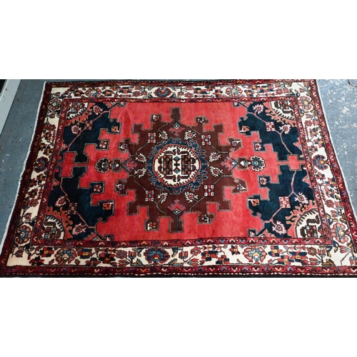 1059 - A contemporary North West Persian Tafresh rug, the brown-red ground with stylised floral medallion, ... 