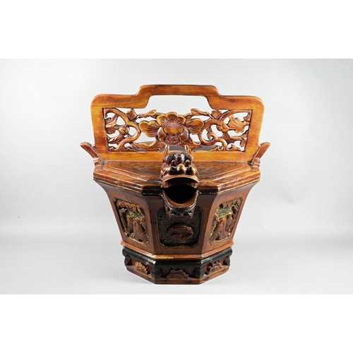 582 - A Chinese stained hardwood water bucket of tapering octagonal form with floral and foliate fret-cut ... 