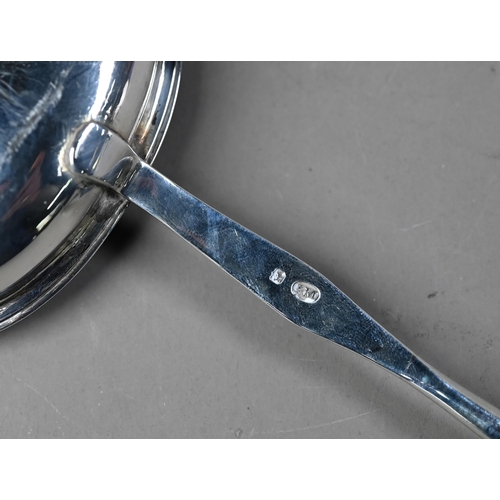 104 - Georgian silver punch ladle with oval bowl and stem, the twisted whalebone handle with silver band, ... 