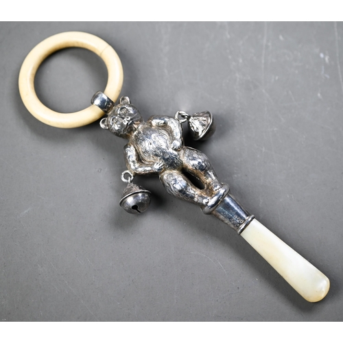 107 - Silver 'teddy bear' baby's rattle with composite teething ring, two bells and mother of pearl handle... 