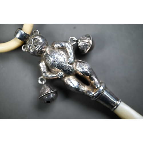 107 - Silver 'teddy bear' baby's rattle with composite teething ring, two bells and mother of pearl handle... 