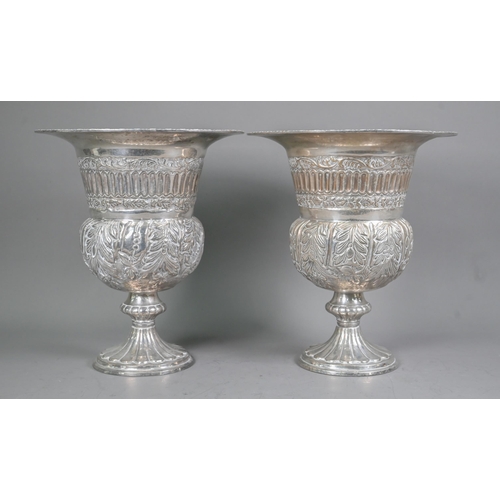 118 - A pair of Continental electroplated champagne ice-buckets in the form of campana urns on stemmed bas... 