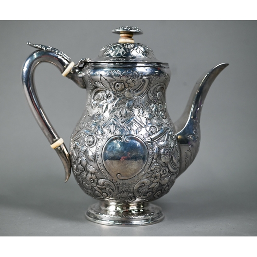 143 - A George III silver coffee pot with embossed decoration and ivory insulators and finial pillar, Edwa... 