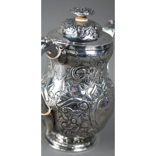 143 - A George III silver coffee pot with embossed decoration and ivory insulators and finial pillar, Edwa... 