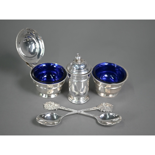 145 - A silver three-piece condiment set with blue glass liners, Birmingham 1932, to/w a pair of Dunstable... 