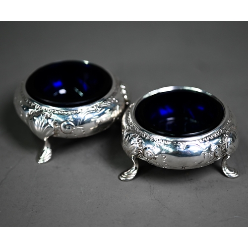 164 - A pair of Victorian circular silver open salts with engraved floral decoration, on hoof feet, Martin... 