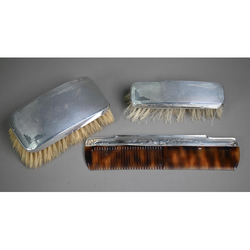 17 - Two Art Deco engine-turned silver-backed brushes, Birmingham 1936, to/w a silver-mounted comb Birmin... 