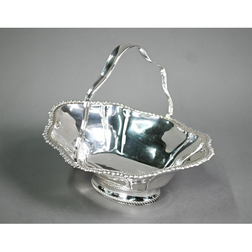 176 - An Edwardian silver basket with swing loop handle and gadrooned rim , on raised oval foot, James Dix... 