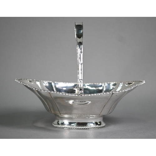 176 - An Edwardian silver basket with swing loop handle and gadrooned rim , on raised oval foot, James Dix... 