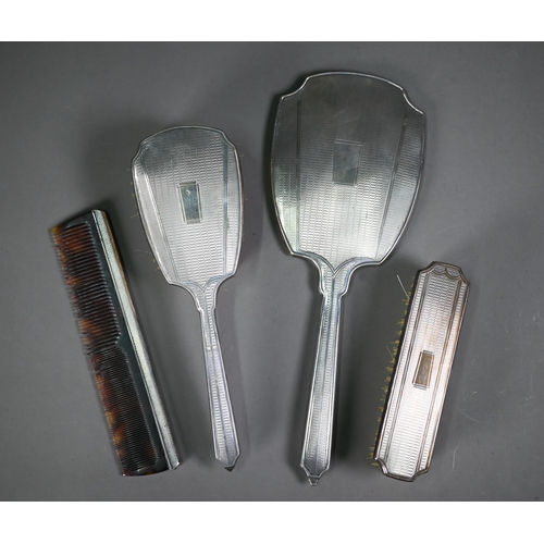 178 - An engine-turned silver four-piece brush set, Birmingham 1961/62, in presentation case