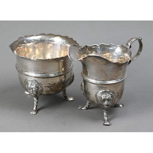 224 - An Edwardian silver cream & sugar pair, with cut rims, scroll handles and lion-mask monopodia, L... 