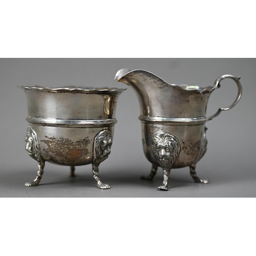 224 - An Edwardian silver cream & sugar pair, with cut rims, scroll handles and lion-mask monopodia, L... 