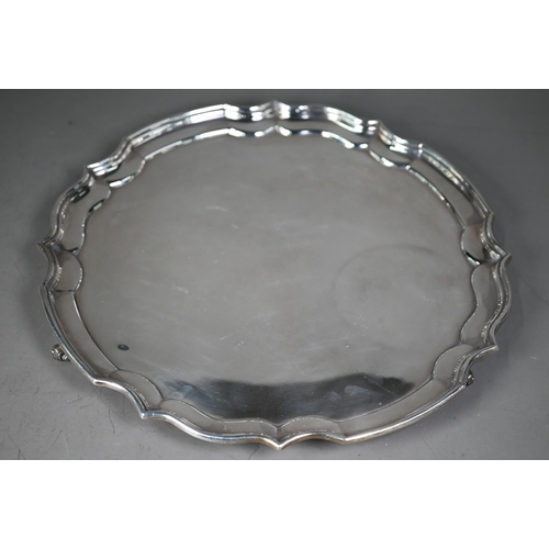 232 - A large silver salver with moulded rim, on three scroll supports, maker HB (script), London 1989, 34... 