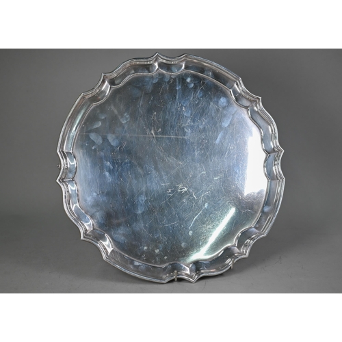 232 - A large silver salver with moulded rim, on three scroll supports, maker HB (script), London 1989, 34... 