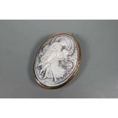 324 - A 19th century Italian oval shell cameo carved in relief featuring two dancing figures, in yellow me... 