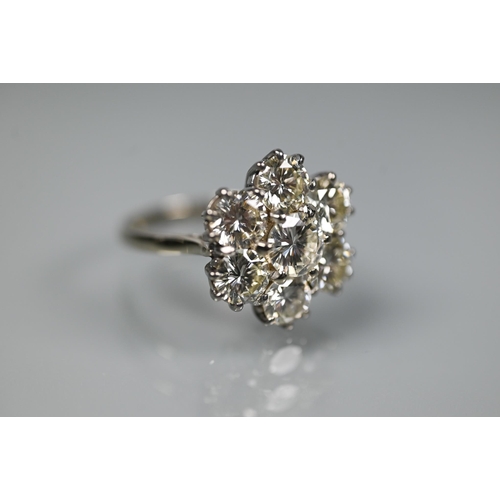 329 - A diamond cluster ring with six round brilliant cut diamonds surrounding a central round brilliant c... 