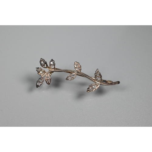 336 - WITHDRAWN An Edwardian diamond brooch in the form of a leaf tendril, the leaves set with old cut dia... 