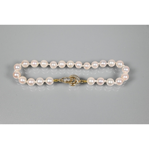 337 - WITHDRAWN A cultured pearl bracelet, the uniform pearls double knotted throughout onto yellow metal ... 