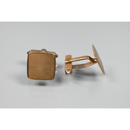 353 - A pair of 9ct yellow gold cufflinks of square design with engine-turned decoration, with swivel back... 