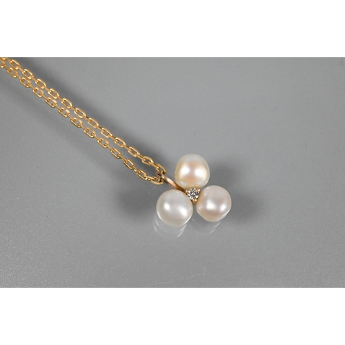 359 - A cultured pearl pendant, the triple baroque pearl cluster surrounding a small cubic zirconia, 9ct y... 