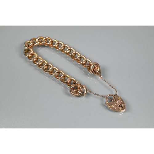 365 - A 9ct rose gold curb bracelet with safety chain and padlock attached, the padlock with engraved init... 