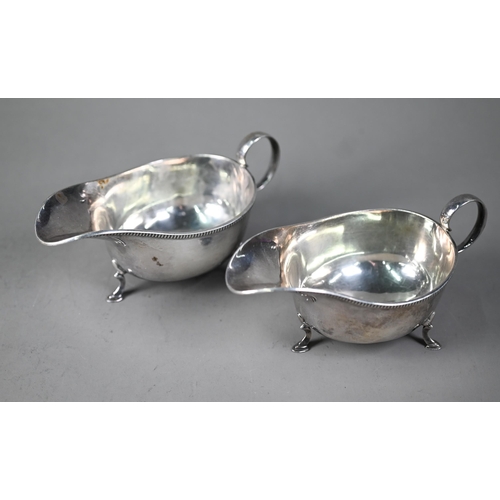 46 - Pair of silver sauce boats with scroll handles and hoof feet, Martin, Hall & Co, Sheffield 1925,... 