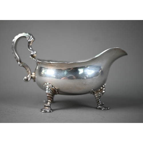 47 - Heavy quality sauce boat in the Georgian manner, with scale-moulded scroll handle and three shell fe... 