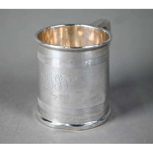 56 - Silver Christening mug in the Georgian manner, of tapering form with reeded bands and scroll handle,... 