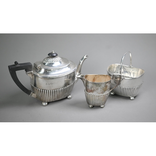 74 - Victorian silver three-piece bachelor tea service of half-fluted oblong form, on later plated bun fe... 