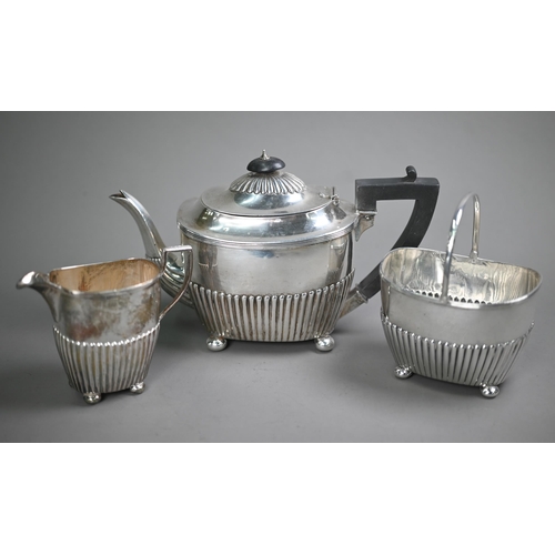 74 - Victorian silver three-piece bachelor tea service of half-fluted oblong form, on later plated bun fe... 