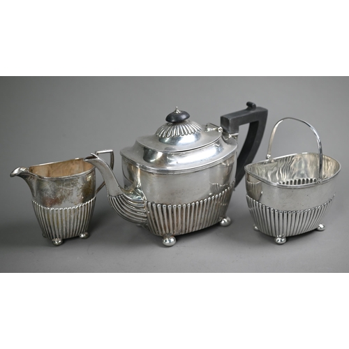 74 - Victorian silver three-piece bachelor tea service of half-fluted oblong form, on later plated bun fe... 