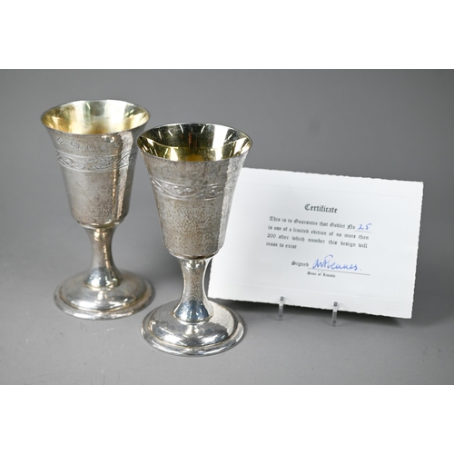 79 - A pair of Lincoln Cathedral planished silver goblets with foliate engraving, limited edition nos. 24... 