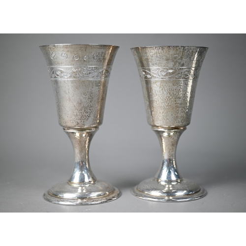 79 - A pair of Lincoln Cathedral planished silver goblets with foliate engraving, limited edition nos. 24... 