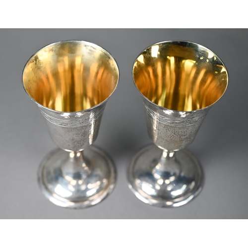 79 - A pair of Lincoln Cathedral planished silver goblets with foliate engraving, limited edition nos. 24... 