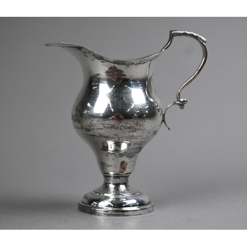 85 - An Edwardian silver baluster cream jug in the Georgian manner, with scroll handle and circular foot-... 