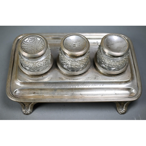 98 - A George IV silver inkstand with three silver-topped cut glass pots, with reeded rim and bracket fee... 