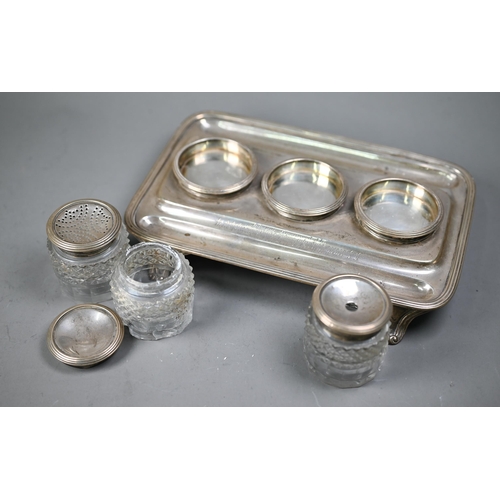 98 - A George IV silver inkstand with three silver-topped cut glass pots, with reeded rim and bracket fee... 