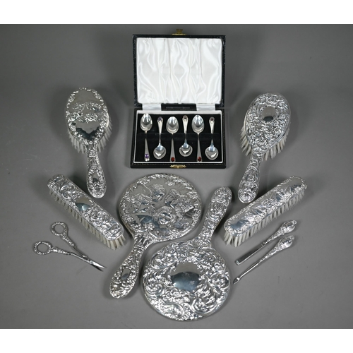 235 - An embossed silver five-piece brush set with hand-mirror, Birmingham 1985, to/w another hand-mirror,... 