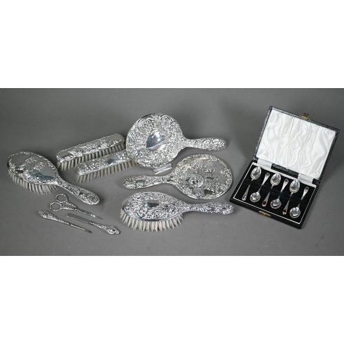 235 - An embossed silver five-piece brush set with hand-mirror, Birmingham 1985, to/w another hand-mirror,... 