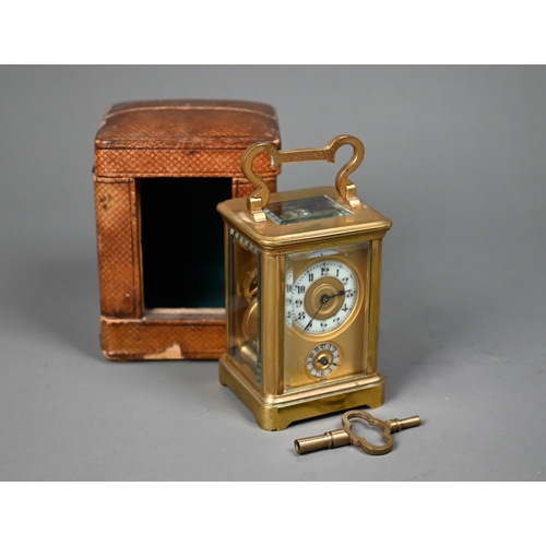 1017 - A miniature brass cased carriage alarm clock, 9 cm h