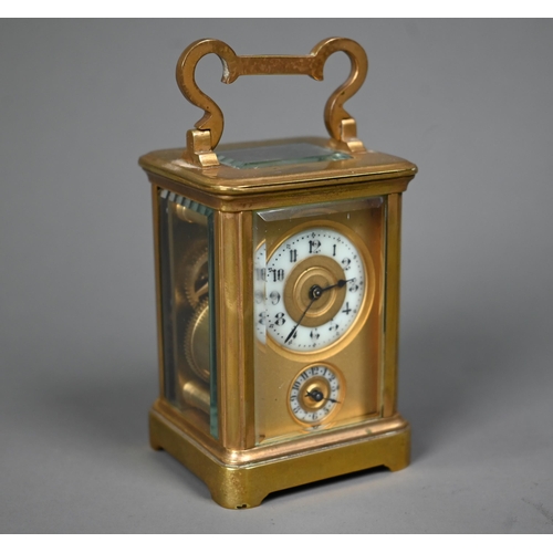 1017 - A miniature brass cased carriage alarm clock, 9 cm h