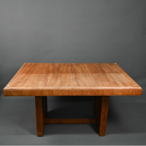 1021 - An Art Deco oak draw-leaf dining table, the top with integral folding central leaf, raised on slab e... 