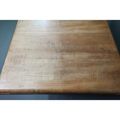 1021 - An Art Deco oak draw-leaf dining table, the top with integral folding central leaf, raised on slab e... 